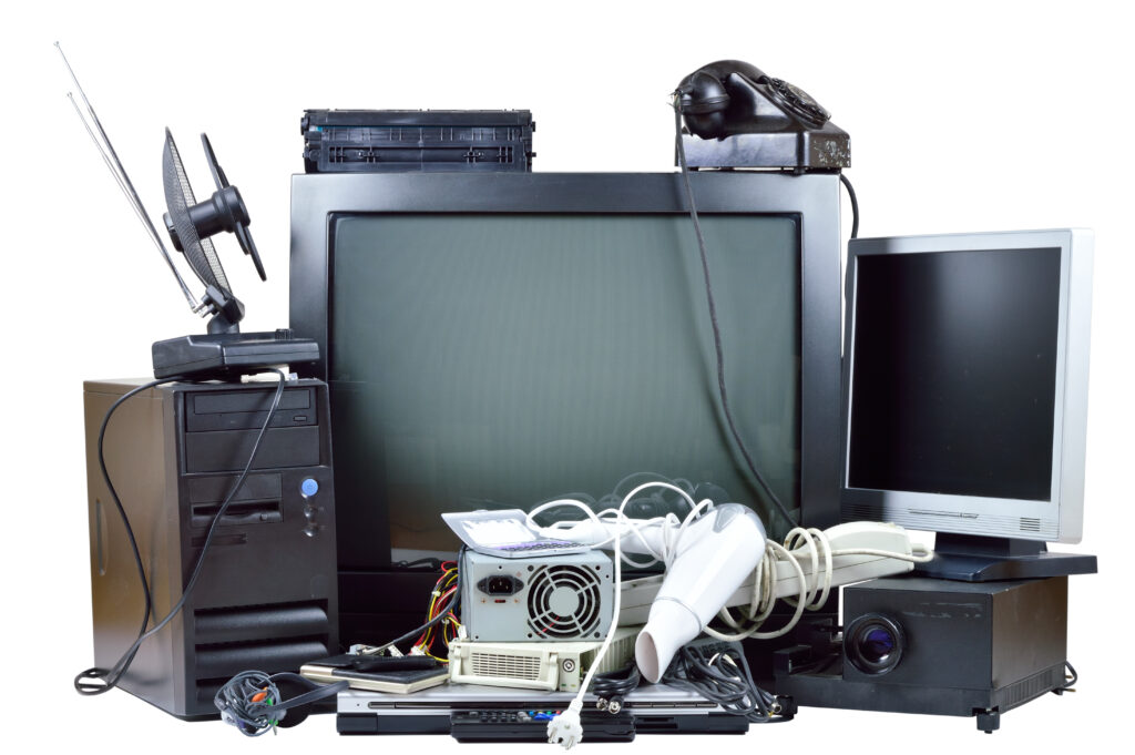 Old and used electric home waste. Obsolete pc computer, telephone, CRT monitor, DVD.